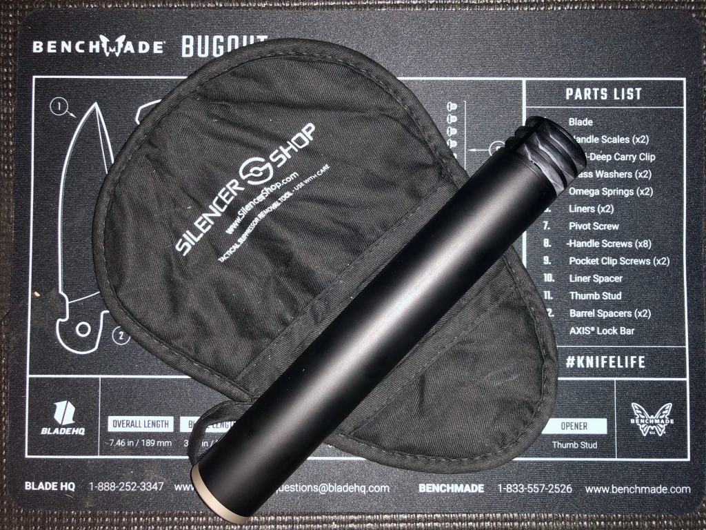 A SilencerCo Harvester 300 suppressor lying on a Silencer Shop removal tool, registered to an NFA trust